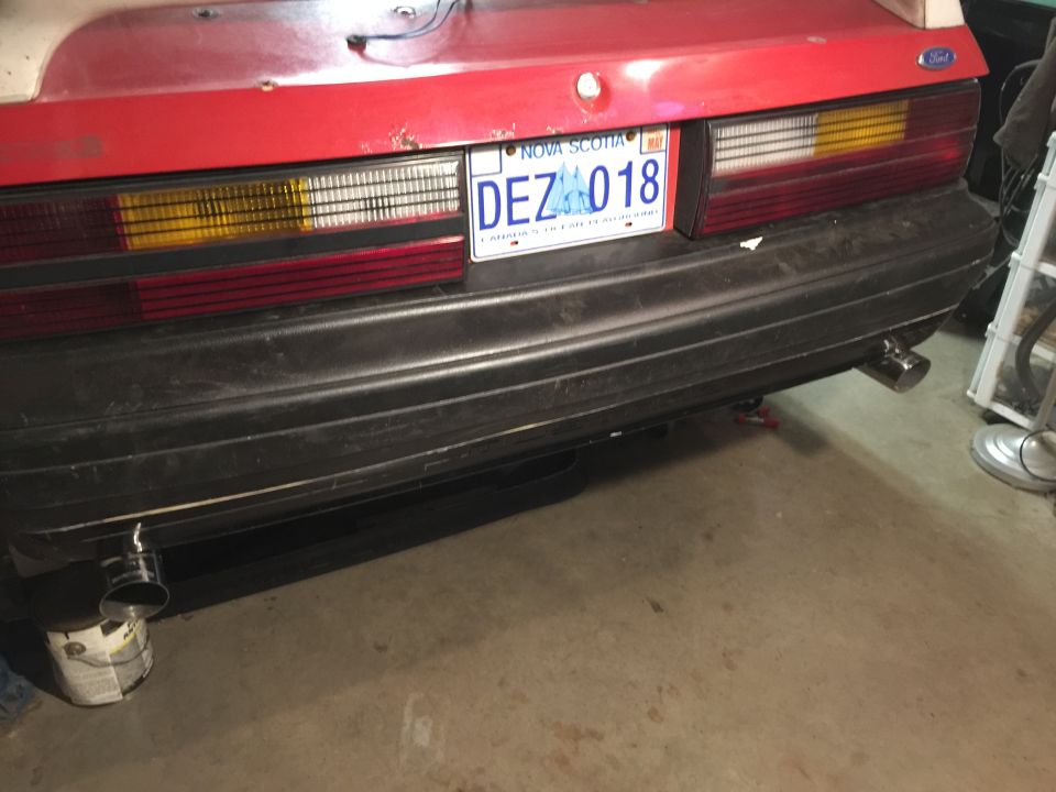 Rear bumper and taillights of a car, with a Nova Scotia license plate reading DEZ 018