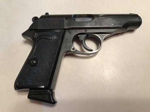 1989 Ford Bronco - A close-up view of a Walther PPK pistol, showing its grip and slide markings.