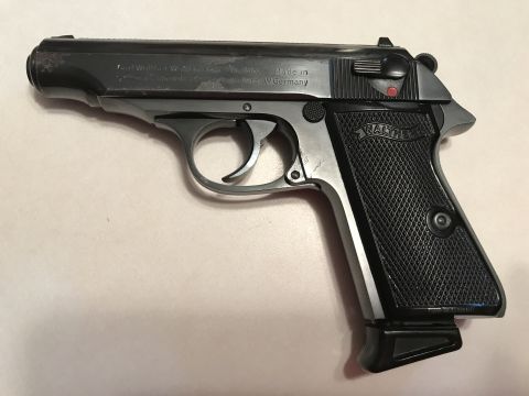 1989 Ford Bronco - A black Walther PPK pistol is shown with its textured grip and markings visible.