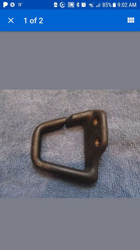 1971 Ford Mustang - This is a metal bracket with a U-shaped loop and two screw holes, likely a car part.
