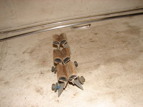 1973 Ford Ranchero - A close-up view shows a cluster of four small, cylindrical, brown, felt-like objects, each split lengthwise and held together by screws and…