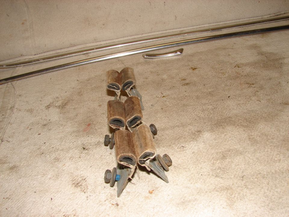 Automotive trim clips or fasteners made of brown felt-like material.