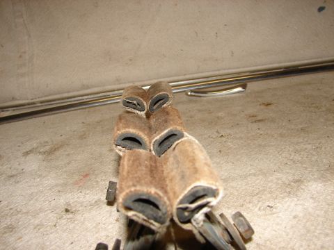 1973 Ford Ranchero - A close-up view shows several brown, fuzzy cylindrical parts with black rubber inserts, possibly some kind of weather stripping or seals, r…