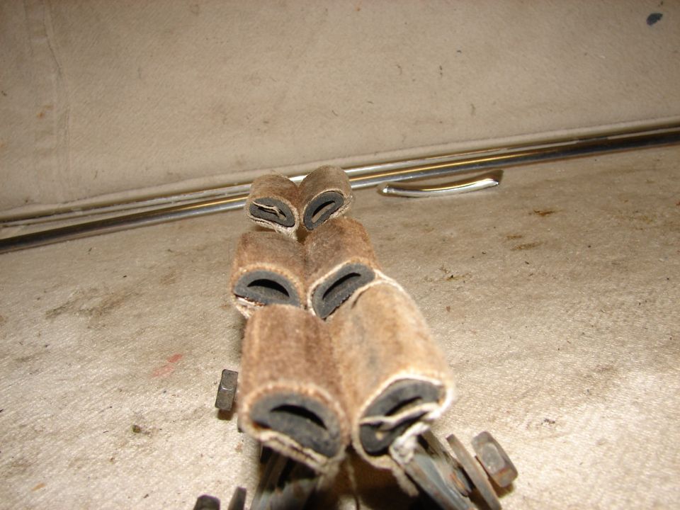 Close-up of fuzzy cylindrical parts with black rubber inserts