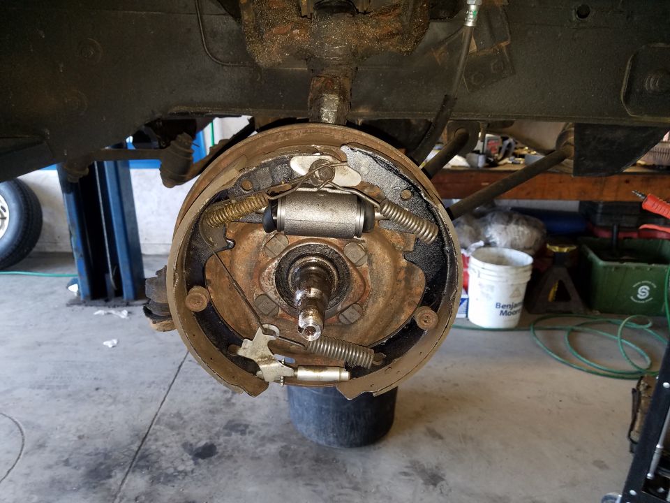 Close-up of a drum brake assembly with brake shoes, springs, and wheel cylinder.