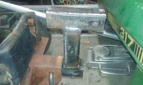 1995 Ford Bronco - A trailer hitch receiver is shown, with a partial view of a green object bearing the number 317.