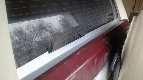 1996 Ford Bronco - Close-up view of the rear window and a portion of the quarter panel of a vehicle.