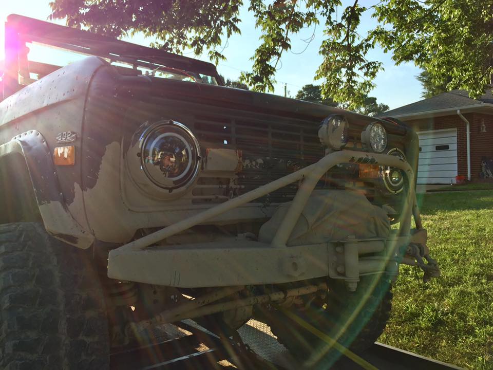 Tan Ford Bronco with aftermarket bumper and winch, front view