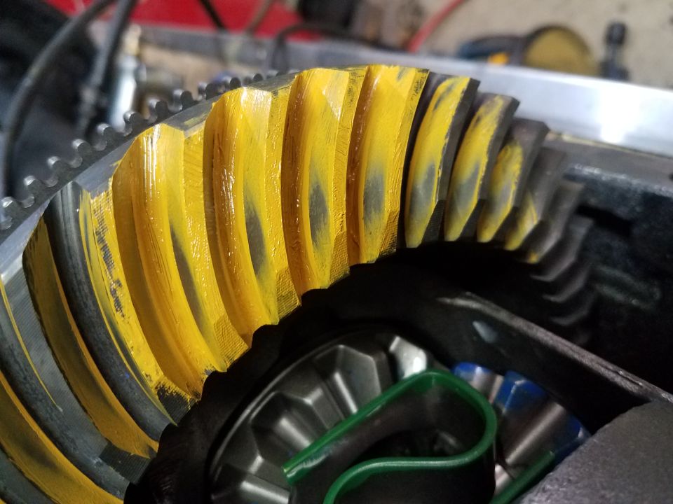 Yellow ring and pinion gear with wear marks