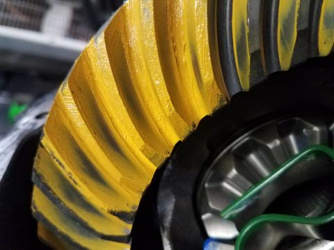 1995 Ford Bronco - Differential ring gear with yellow paint applied to the teeth for inspection.