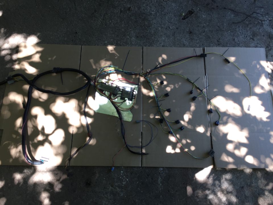 Pulled the entire harness out of the car to wrap it up. The whole thing pretty much pops out as a single harness. All the wires terminate in OEM or at least OEM-style connectors. The Megasquirt 37-pin connector has to have the shell removed to fit through the firewall but it's not a big hassle.
