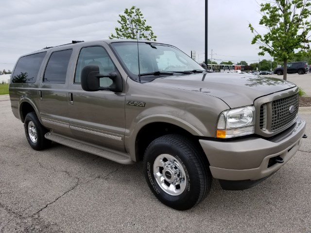 2003 Ford Excursion SUV, tan exterior, parked on asphalt