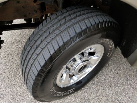2003 Ford Excursion - Close-up of a vehicle's tire and wheel assembly, with visible chassis components.