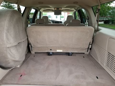 2003 Ford Excursion - The spacious cargo area of the SUV, with the rear seats folded down, reveals ample storage space.