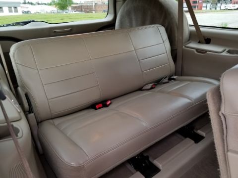 2003 Ford Excursion - The interior view shows the tan leather rear seats and seatbelts.