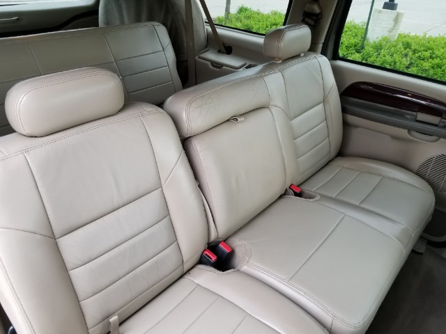 Tan leather rear bench seat inside a Ford SUV