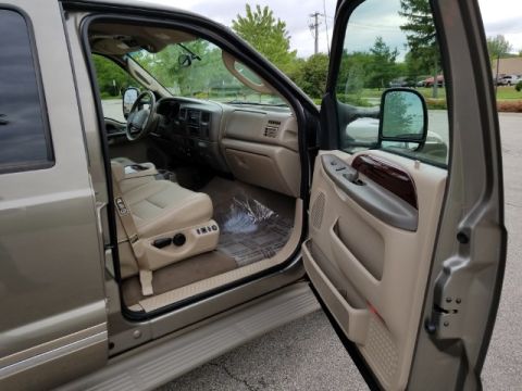 2003 Ford Excursion - Interior view of a 2003 Ford Excursion, its tan leather seats and dashboard.