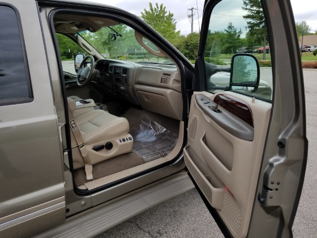 Tan interior of 2003 Ford Excursion with leather seats and open doors