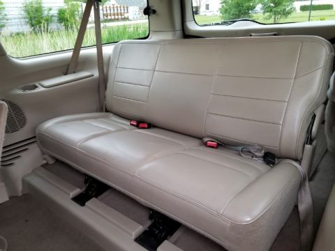 2003 Ford Excursion - The rear bench seat of a 2003 Ford Excursion is shown from the side.