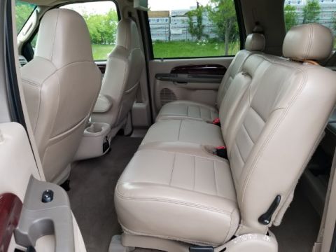 2003 Ford Excursion - Interior view of a 2003 Ford Excursion, highlighting the beige leather seating arrangement.