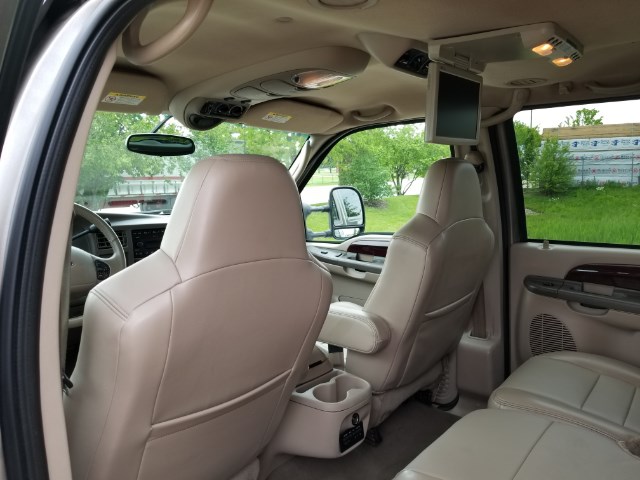Tan leather interior of crew cab truck with overhead DVD screen