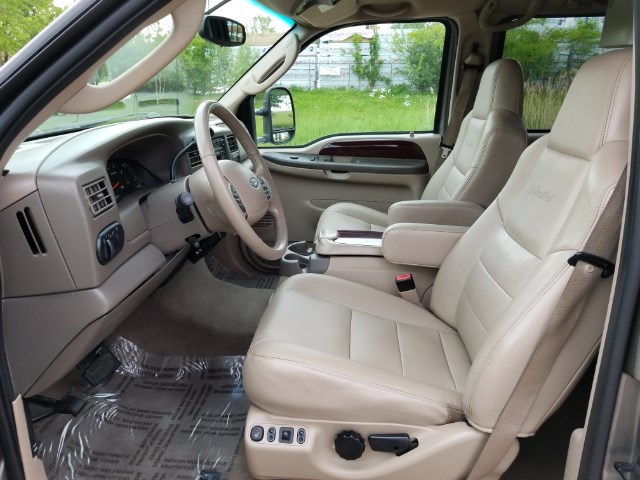 2003 Ford Excursion interior showing front seats, dashboard, and steering wheel