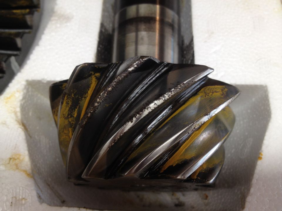 close-up of a worn differential gear with yellow staining