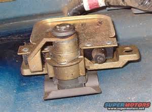 1994 Ford Bronco - Photograph of a worn hood latch assembly mounted on its bracket.