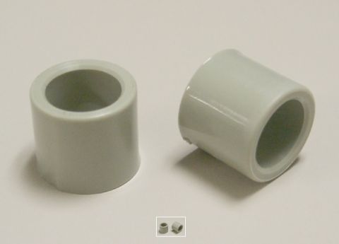 1994 Ford Bronco - Close-up photo of a pair of gray plastic bushings with two small fasteners below them.