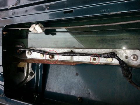 1994 Ford Bronco - In-door photo of a window glass run channel rail with two mounting bolts circled in red.