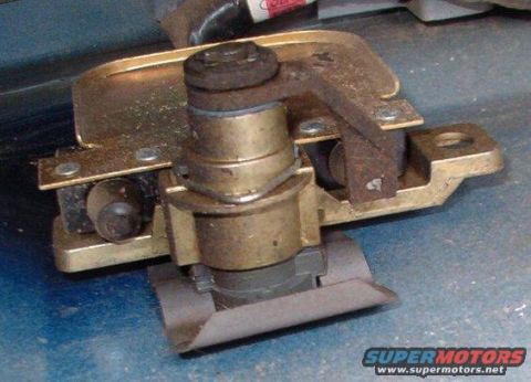 1994 Ford Bronco - Photo of an installed tailgate latch and lock cylinder assembly with brass housing.