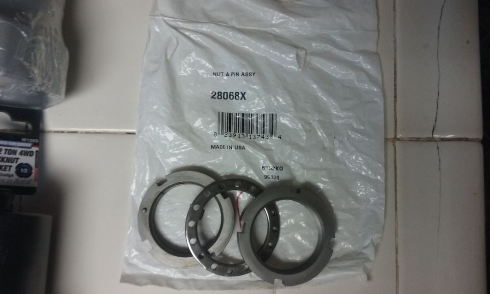 Nut and pin assembly part with three metal rings underneath.
