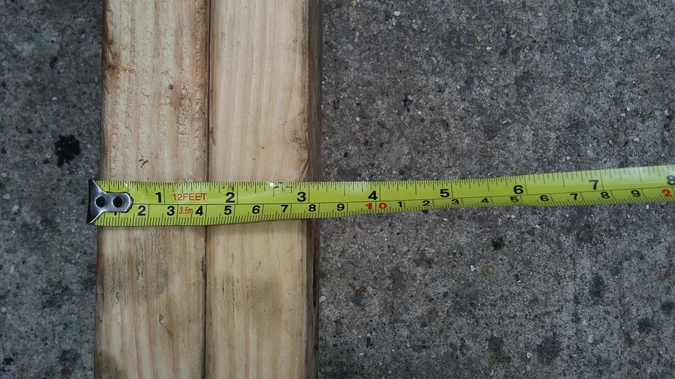 Yellow measuring tape on a wooden surface