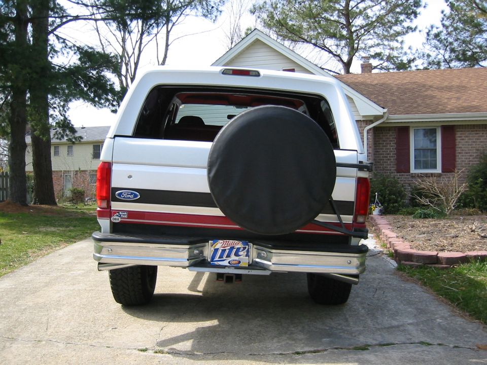 Rear view of a white 1993 Ford Bronco with a spare tire on the back