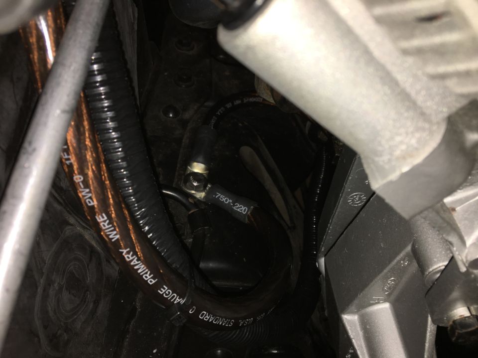 Thick copper wiring with black corrugated tubing, showing text labels.