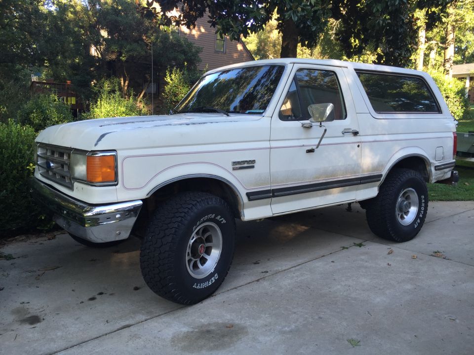 White 1988 Ford Bronco parked on a driveway.