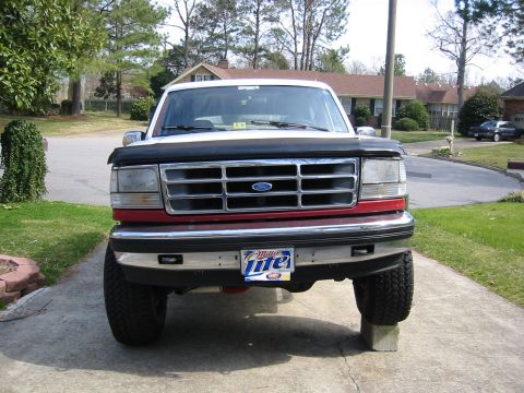 1993 Ford Bronco - This 1992 Ford Bronco features a distinctive grille and red body trim, seen from the front.