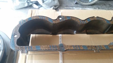 1981 Ford Bronco - A close-up view of a black valve cover gasket with blue and cork material, resting on cardboard boxes.