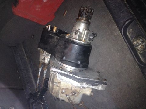 1995 Jeep YJ - Close-up view of a vehicle's transfer case, showing internal components and metal casing.