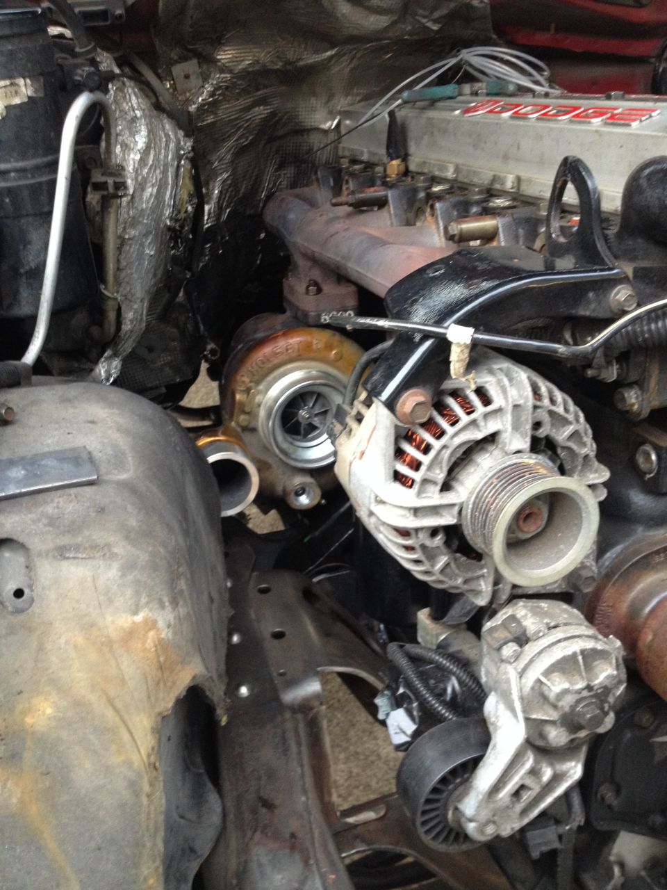 Close-up of turbocharger and alternator on a diesel engine.