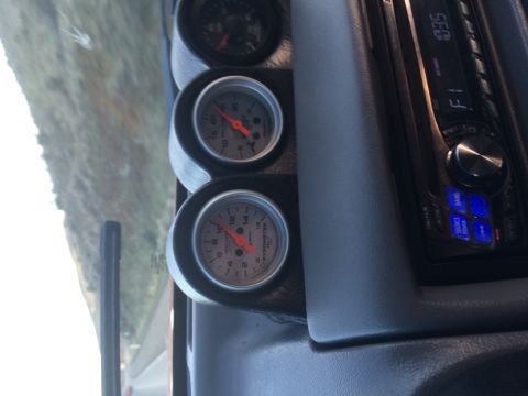 1995 Jeep Wrangler - A close-up interior shot shows a dashboard with three gauges and a car stereo. The gauges appear to be measuring exhaust gas temperature an…