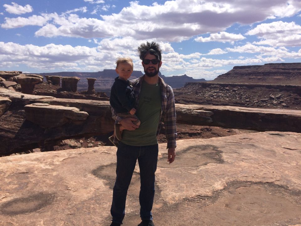 Man holding child in desert landscape