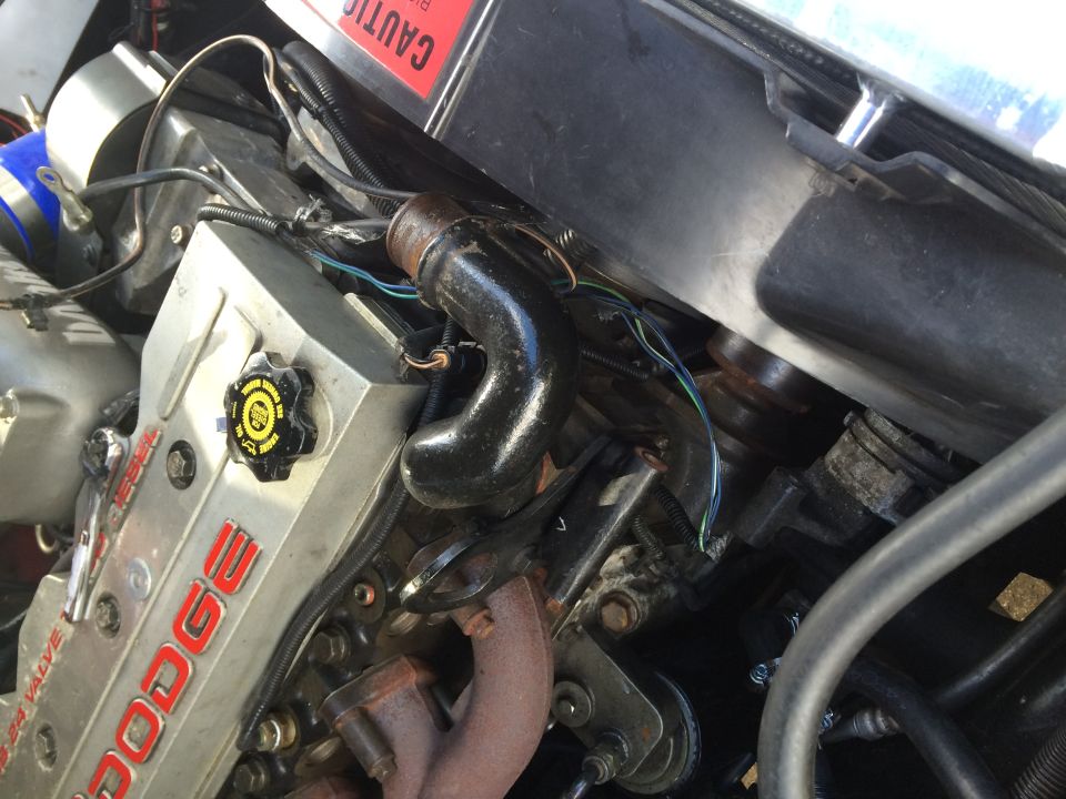 Dodge 5.9L 24 Valve Diesel engine with exhaust manifold and oil cap.