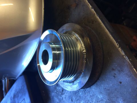 1995 Jeep Wrangler - A close-up shot shows a newly welded, multi-groove pulley attached to a metal bracket. The pulley is shiny and metallic, with visible weld…