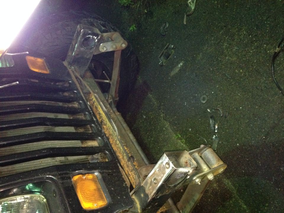 Custom trailer hitch fabrication on a black Jeep YJ bed.