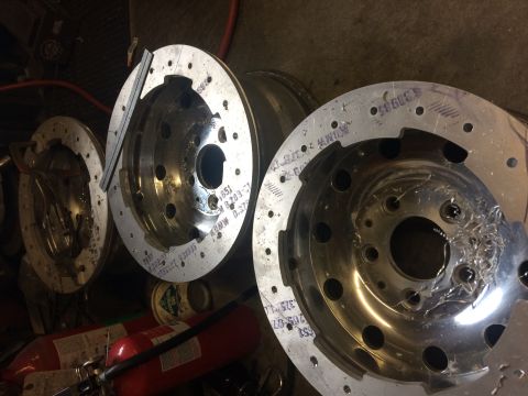 1995 Jeep Wrangler - Three custom aluminum wheel hubs are shown, with one in the foreground exhibiting significant machining marks and debris. The hubs are circ…