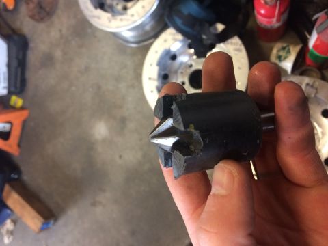 1995 Jeep Wrangler - A hand holds a black, cone-shaped tool with a metal shaft protruding from the back. The tool has a pointed, star-shaped tip with visible da…