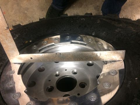 1995 Jeep Wrangler - A close-up view shows a metal ruler being used to measure a tire and wheel assembly. The tire has aggressive tread, and the wheel is silver…