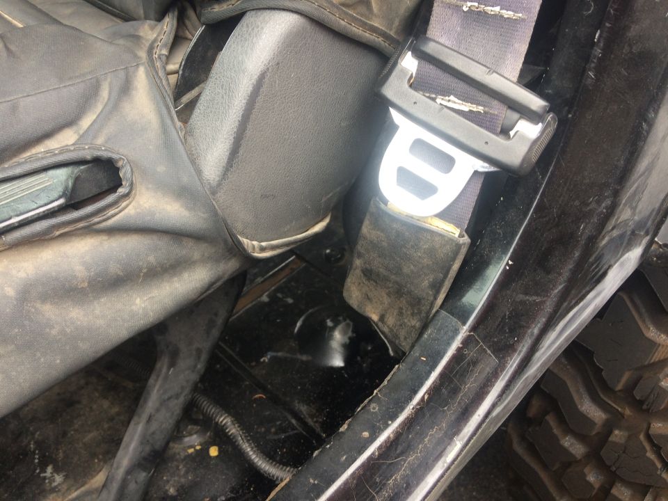 Close-up of a modified Jeep interior, showing custom rocker panel work