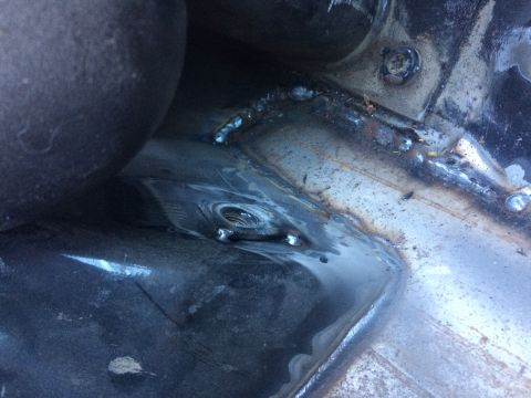1995 Jeep Wrangler - Close-up view of a modified vehicle frame, showing welding and a threaded bolt hole.